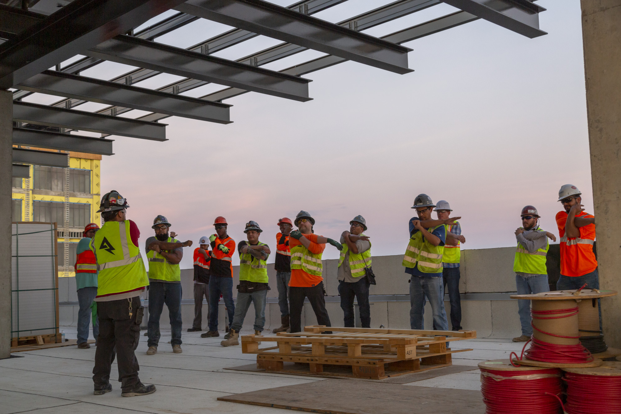 Group of construction workers stretching