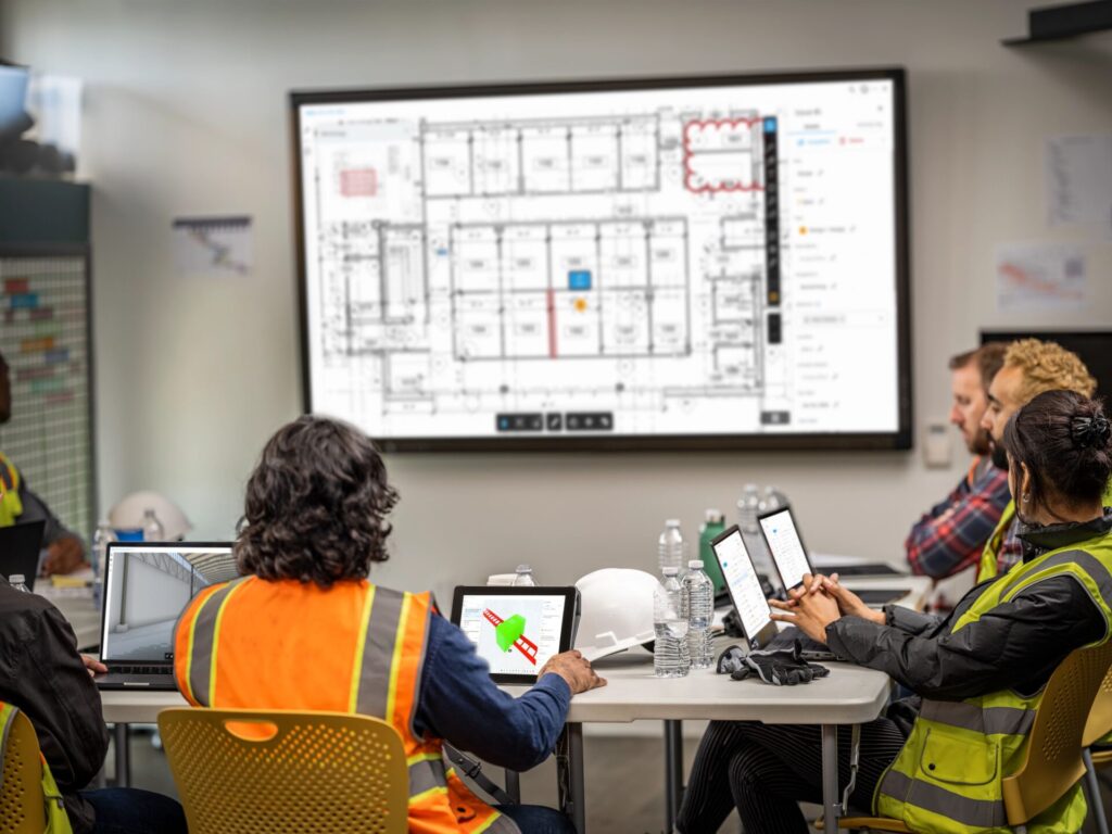 Construction team reviewing issues and markups using Autodesk Docs.
