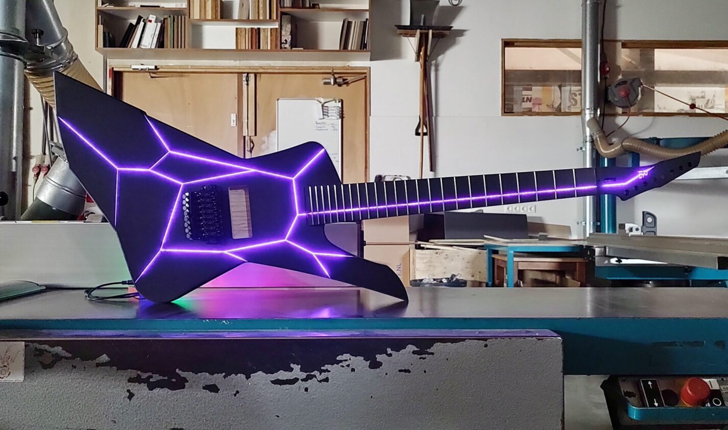 Image of electric guitar with purple LED lights in body and fret