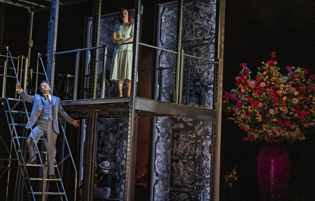 Two level set design with man walking down stairs 