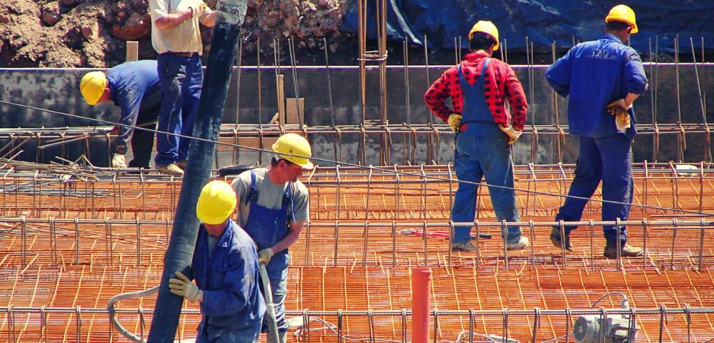 Builders reviewing material costs on a jobsite