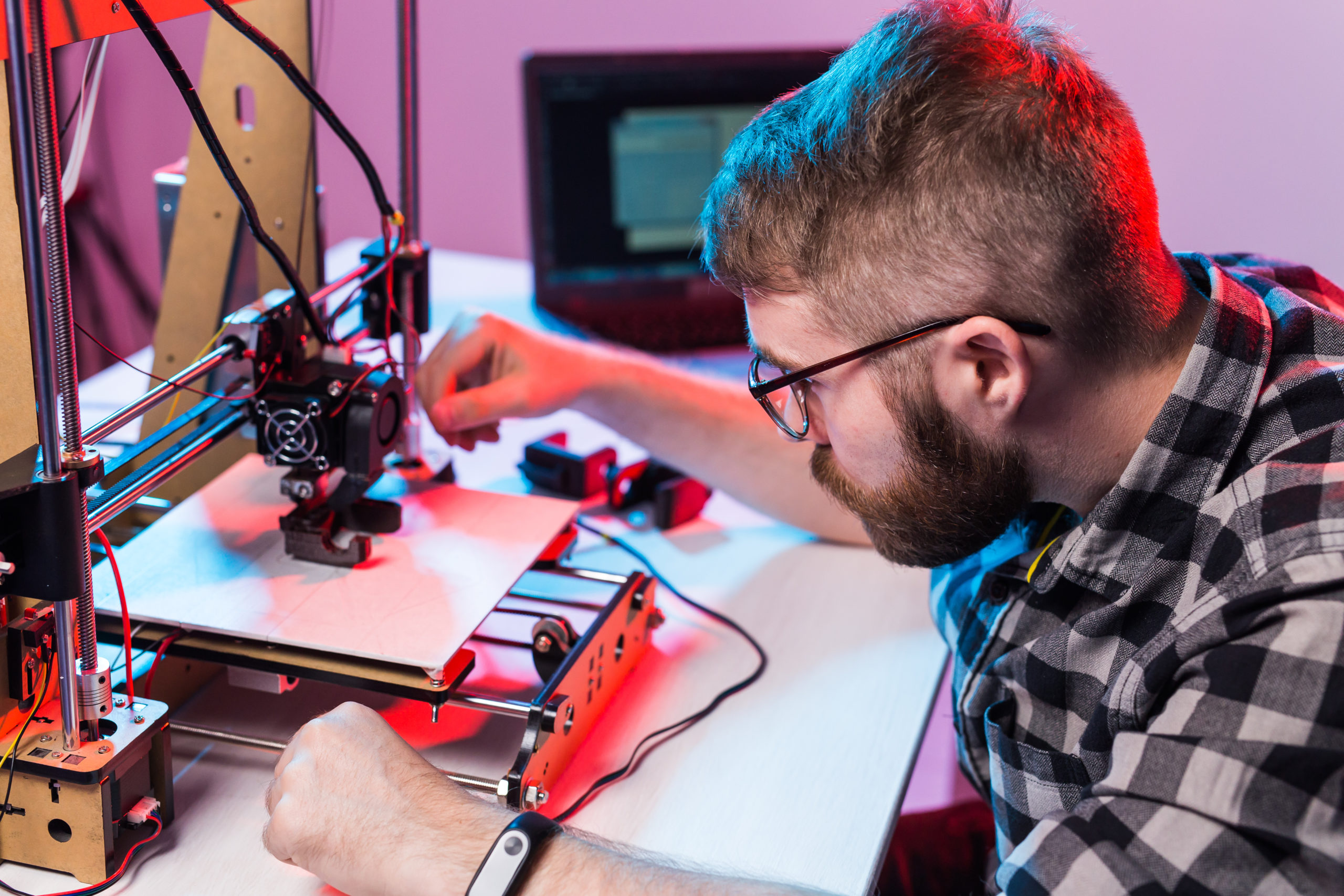 Young Male Designer Engineer Using A 3d Printer In The Laborator