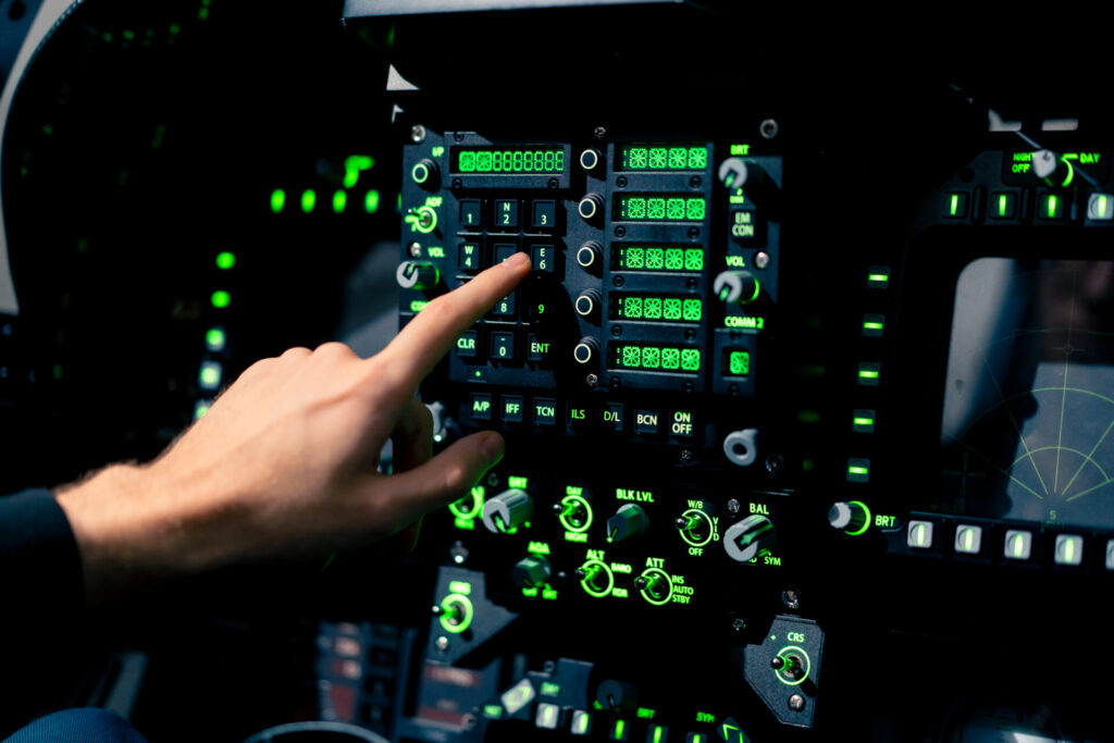 Close-up hand of the pilot captain presses the buttons on the control panel to start the engine of plane Flight simulator close-up