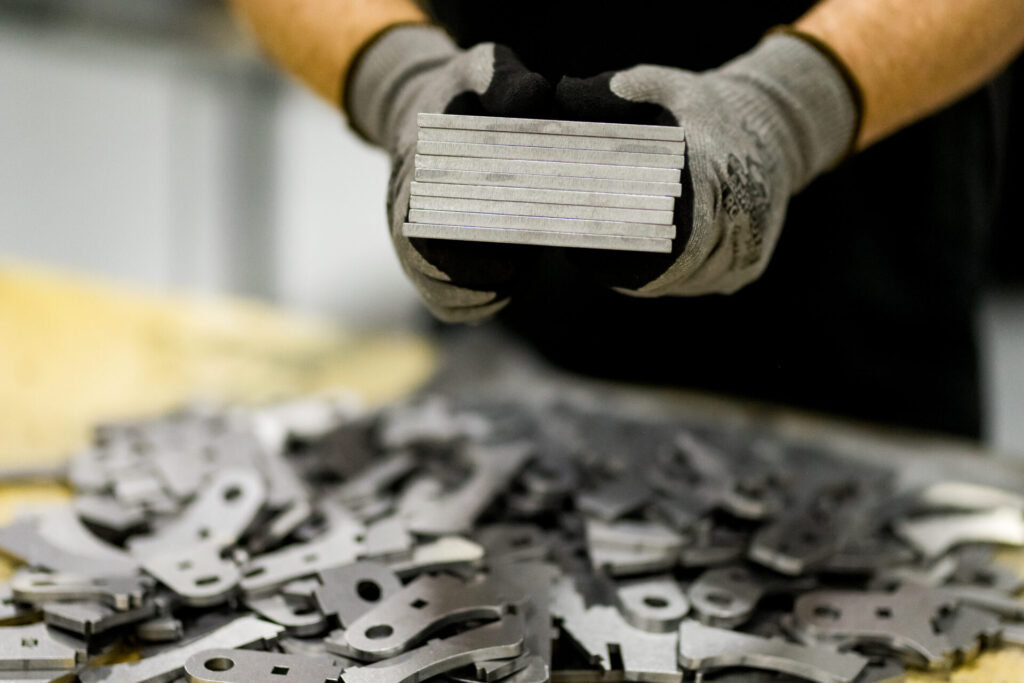 Engineer holding a metal prototype